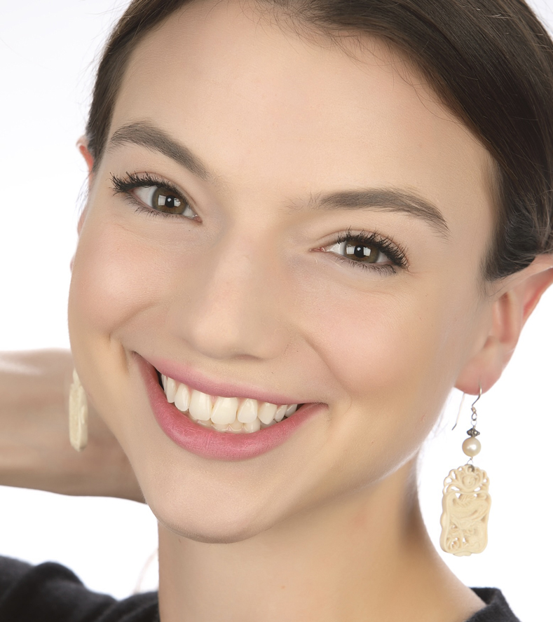 Woman Wearing Pearl and Ivory Bali Earrings