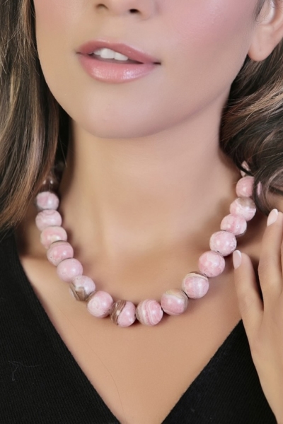 Woman Wearing Rhodochrosite Necklace