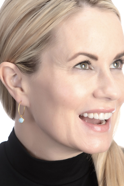 Woman Wearing Brag Stone on Gold Swedish Hoop Earrings