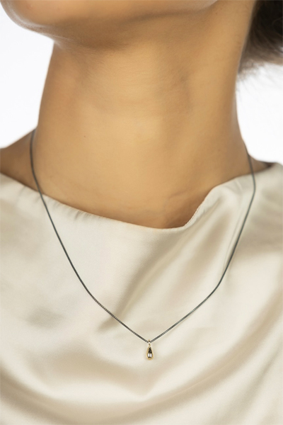 Woman Wearing Golden Drop in Dutch Necklace