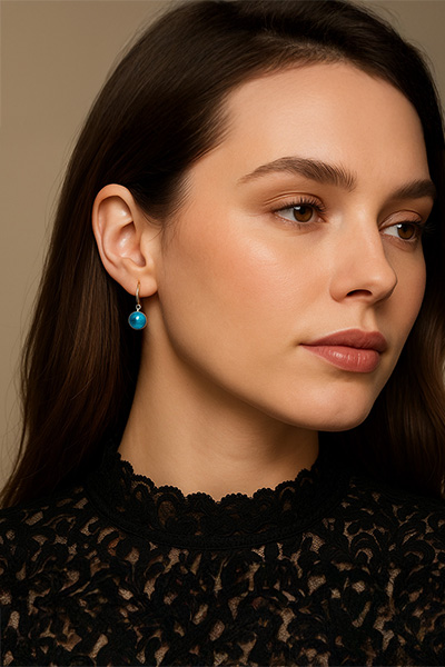 Woman Wearing Smaller Swedish blue Brag Stone Earrings with a Fish Hook Back