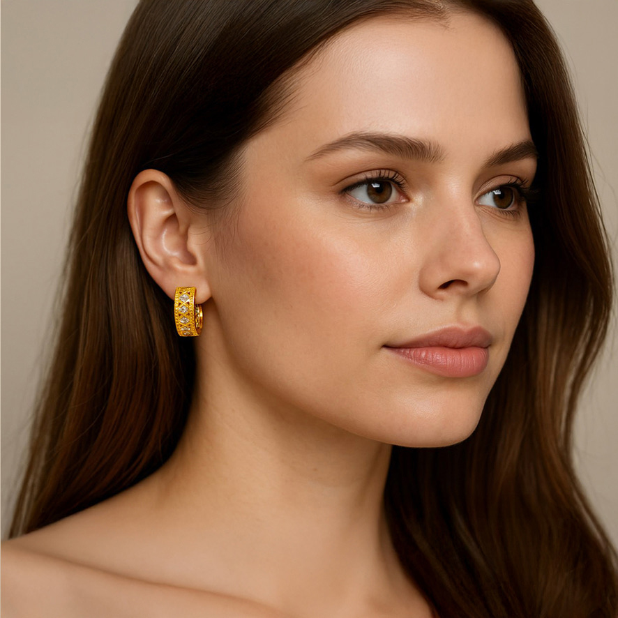 Woman Wearing Gold and Diamond-like Hoop Earrings