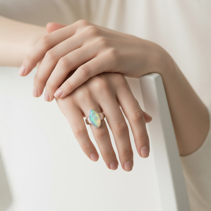 Female hand wearing Cabochon Marquise Opal Ring